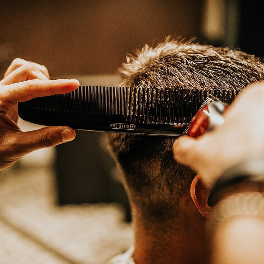 Comb and clippers working through the back of a cut