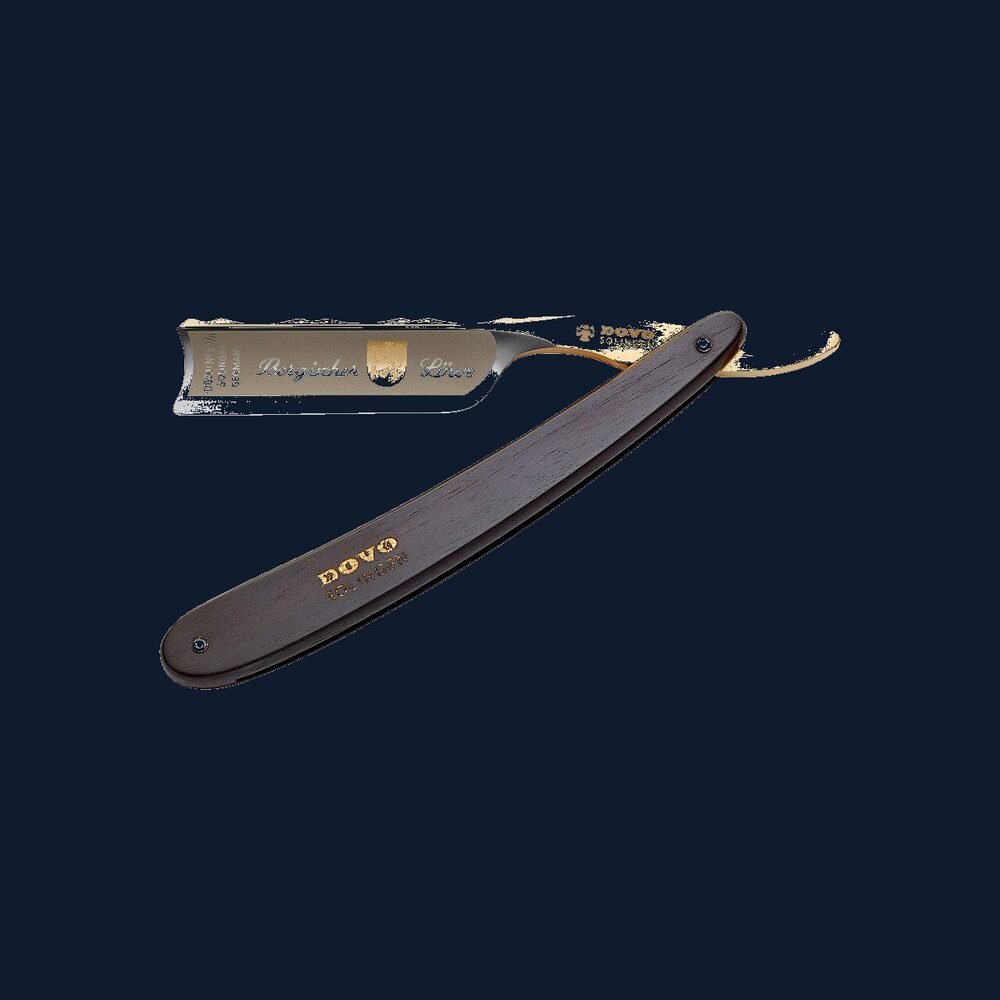 Straight razor open on a dark surface